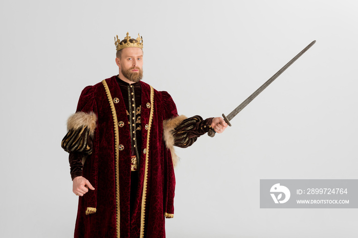 king with crown holding sword isolated on grey