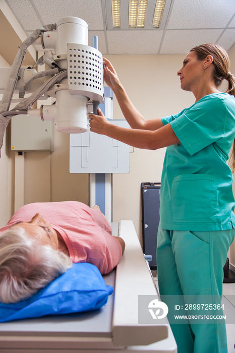 Senior retired woman undergoing medical test under expert female doctor supervision