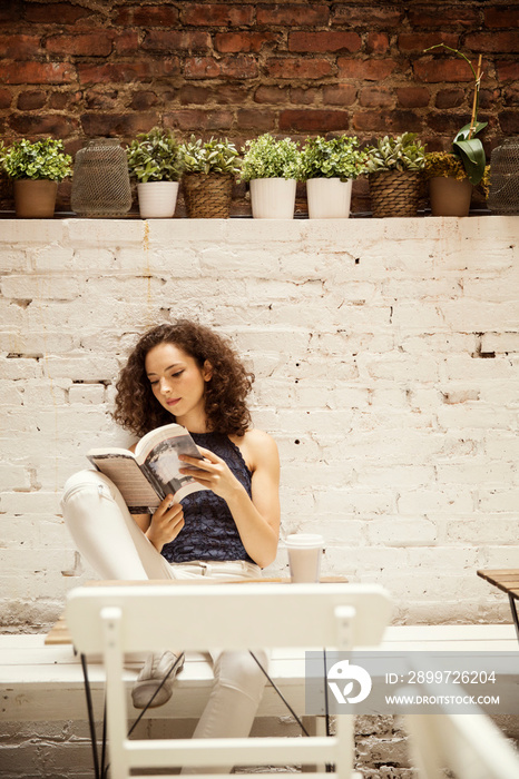 Woman reading book outdoors