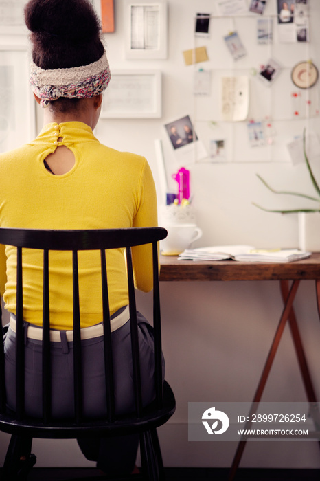 Young woman sitting in office at home