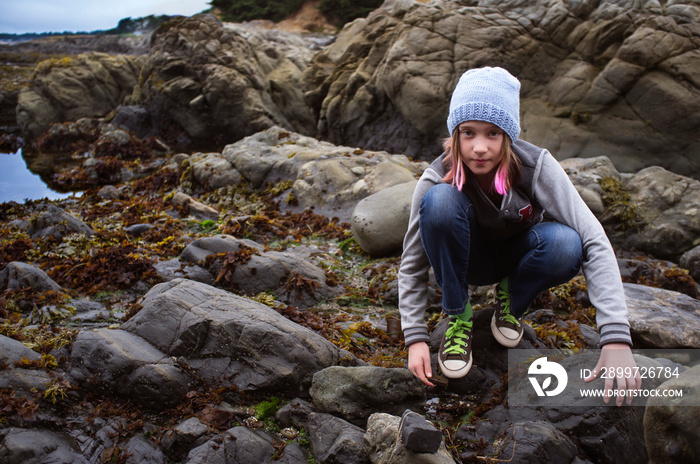 Portrait of girl (10-11) exploring beach