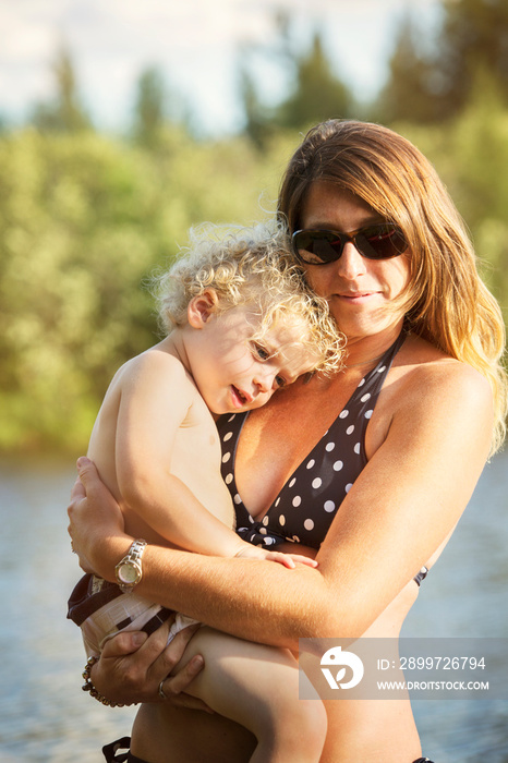 Portrait of happy mother and daughter (2-3) by lake