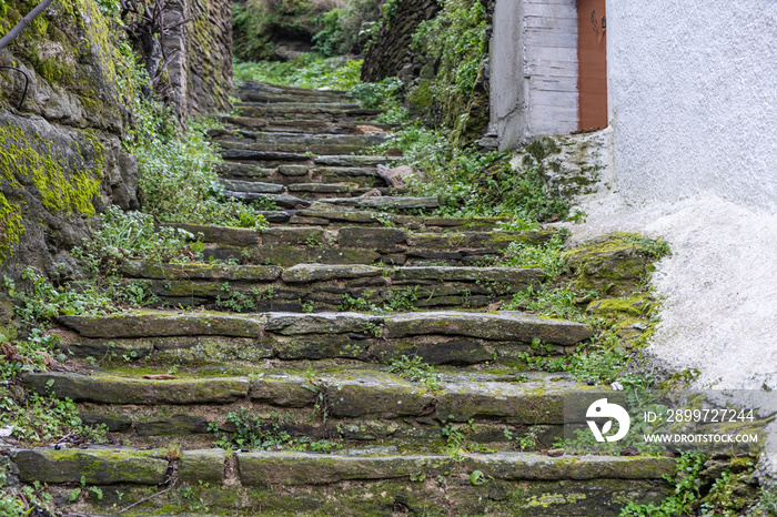 Greece, Tzia Kea island. Ioulis city narrow street with stairs and traditional stone walls