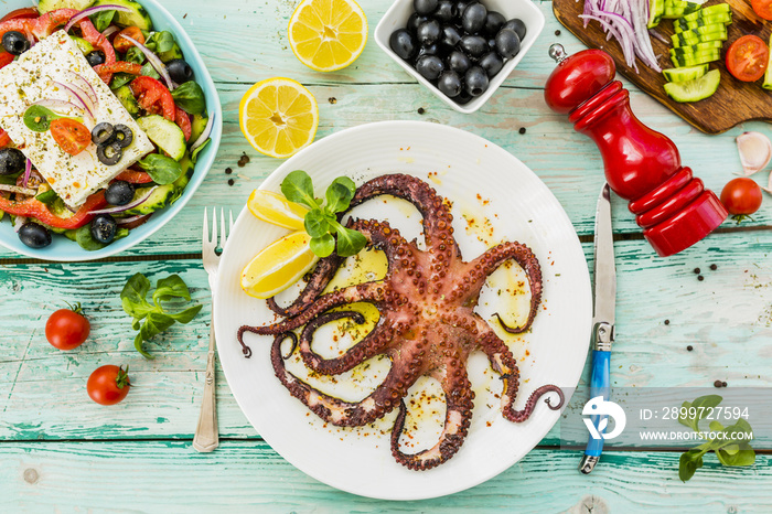 Grilled octopus served on white plate. Mediterranean food.