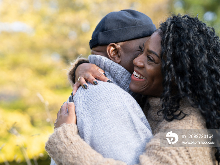 Portrait of couple embracing in nature