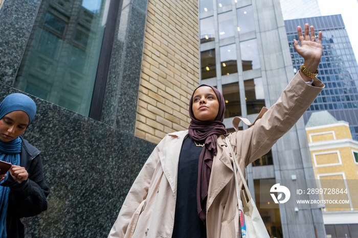 Two women wearing�hijabs�waiting for taxi