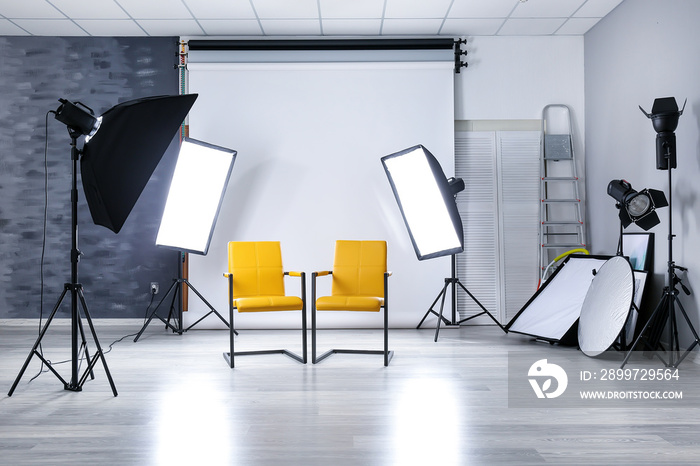 Photo studio with modern interior and lighting equipment