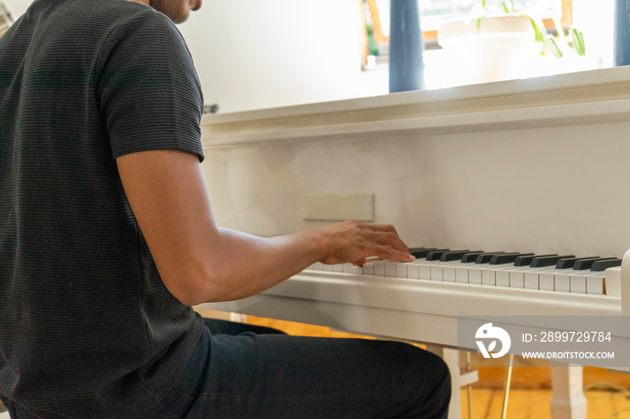 UK, London, Midsection�of man playing piano