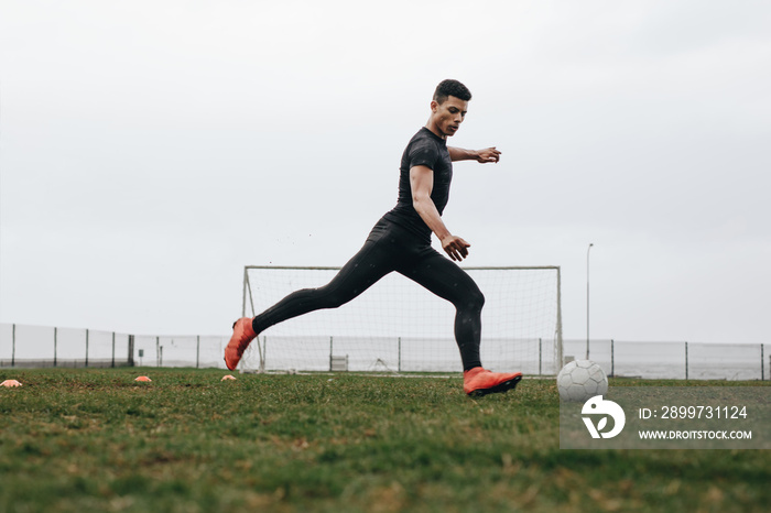 Football player practicing on field