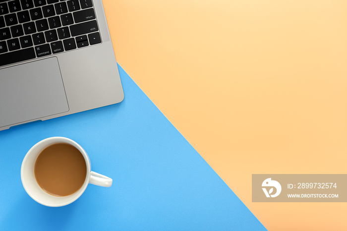 Laptop and coffee cup on blue and orange background