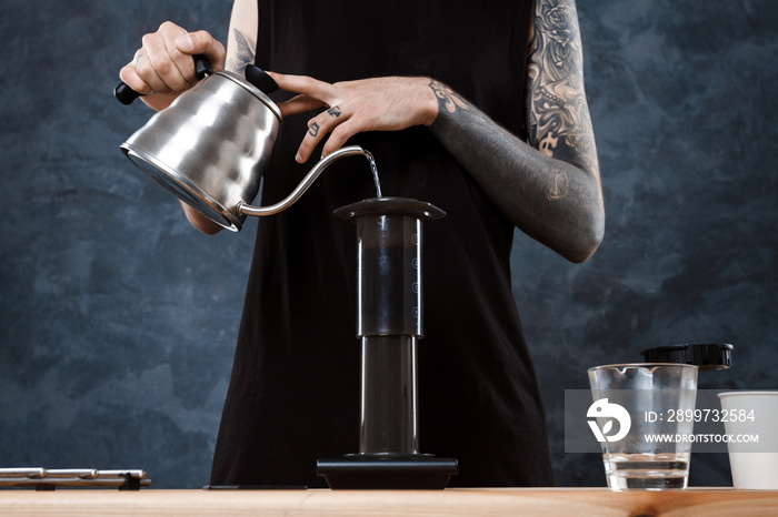 Male barista brewing coffee. Alternative method aeropress.