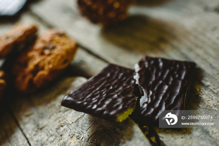 Black chocolate filled with mint cream on wooden background