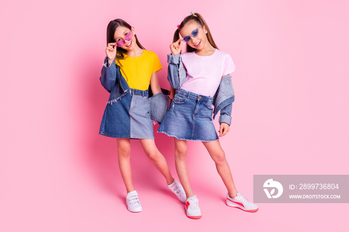 Full size photo of optimistic brunette blond girls wear yellow pink t-shirt skirts isolated on pink 