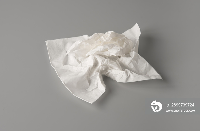 Crumpled tissue paper on gray background