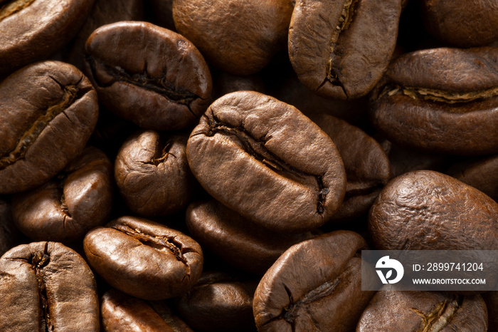 Brown roasted coffee beans close up full frame as a background