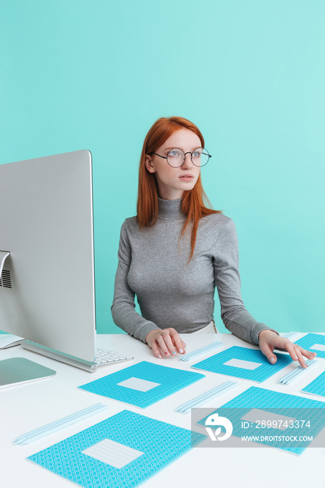 Confident woman sitting at the table with copybooks and pencils