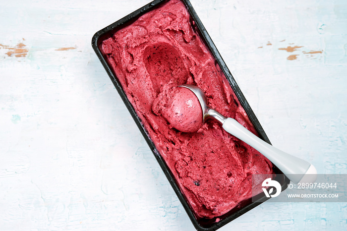 Top view of red berries sorbet with scoop