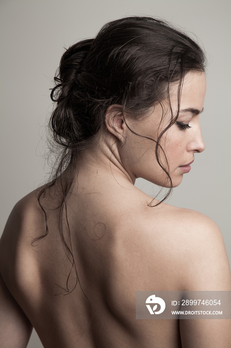 natural beauty concept woman with wet hair in bun profile studio shot