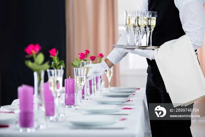 Waiter Serving Banquet Table