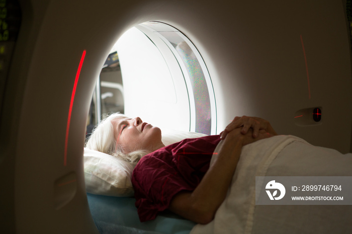 Woman going through MRI scanner