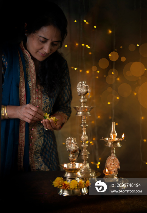 Woman adding flower on lamp