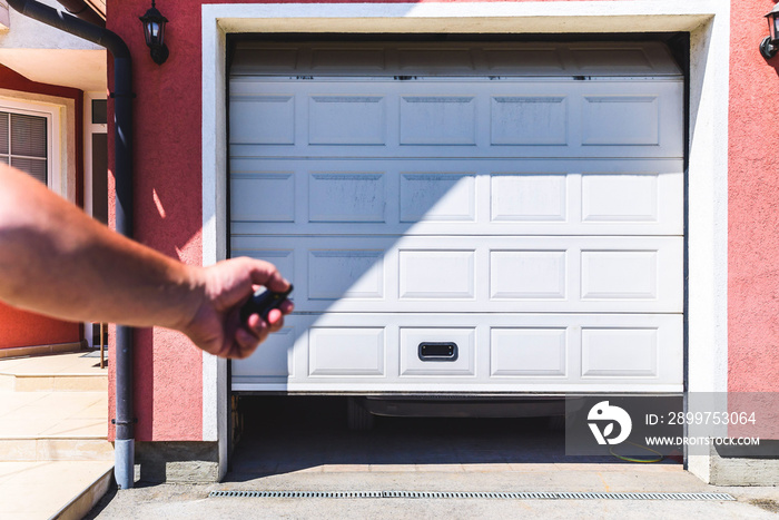 Garage door PVC. Hand use remote controller for closing and opening garage door.