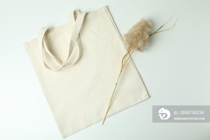 Eco bag and reeds on white background
