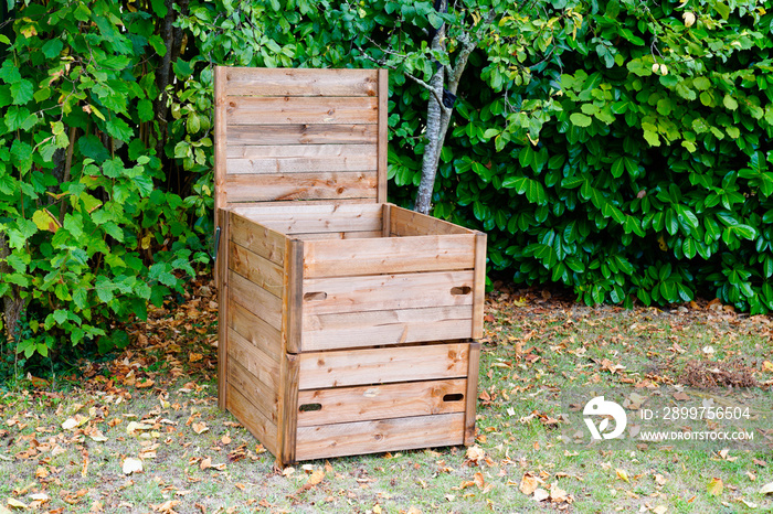 wooden compost bin in home garden for recycling organic material