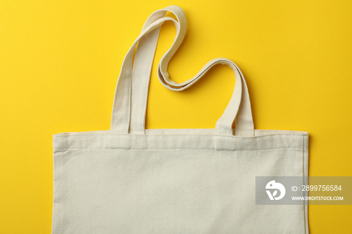 Blank eco bag on yellow background, space for text