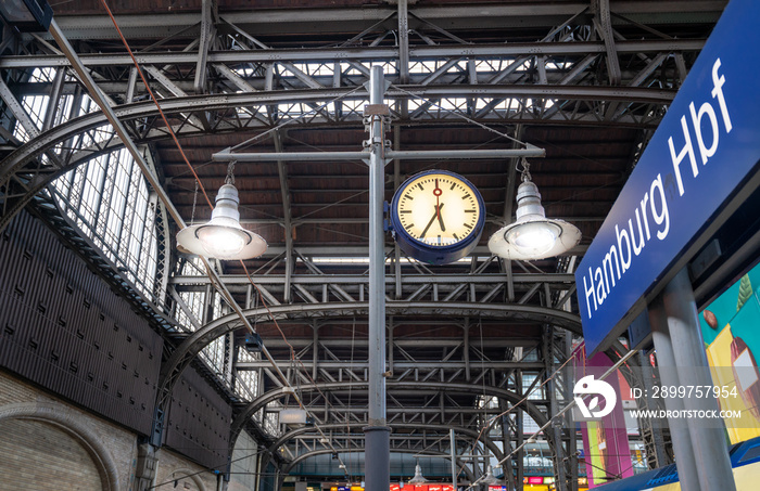 The central station of Hamburg, Germany. Focus on a plate with the text  Hamburg Hbf  ( Hbf  abbrevi