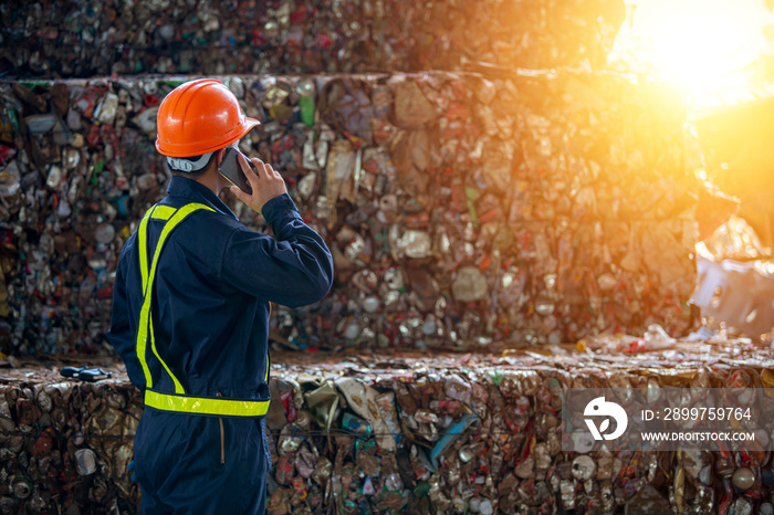 A man calling manager bottles pressed and packed for recycling