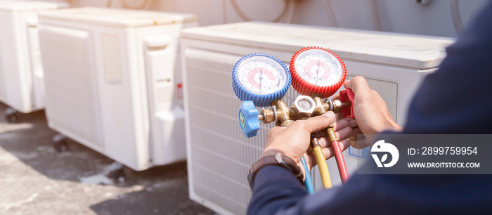 Technician is checking air conditioner ,measuring equipment for filling air conditioners.