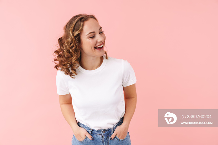 Pretty woman posing isolated over pink wall background.