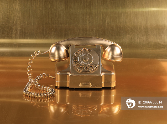 vintage gold phone on gold background