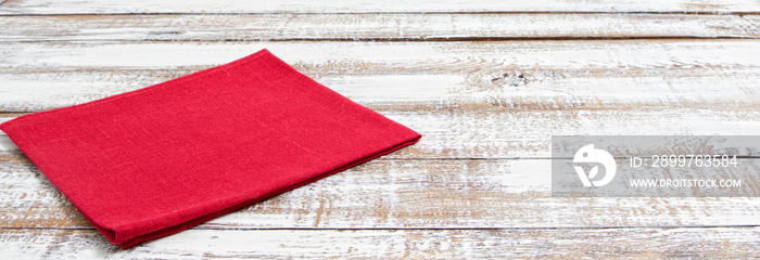 coloured napkins on empty wooden table - top view, copy space