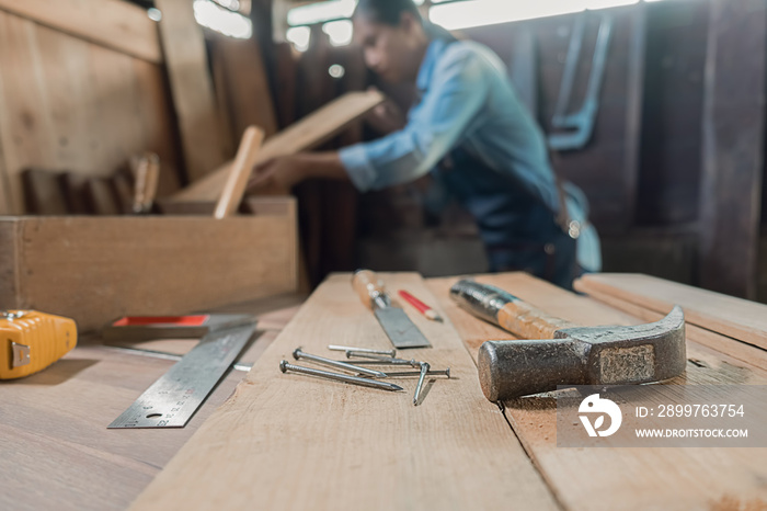 Carpenter on workplace in carpentry workshop.