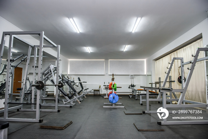 Modern interior of light gym with different equipment