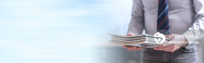 Man holding magazines. panoramic banner