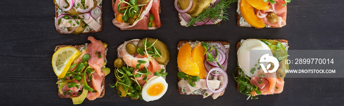 panoramic shot of fresh smorrebrod sandwiches on grey surface