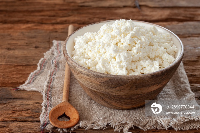 Cottage cheese in a wooden bowl