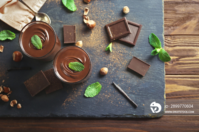 Chocolate mousse with mint in portion glasses on slate cheese board