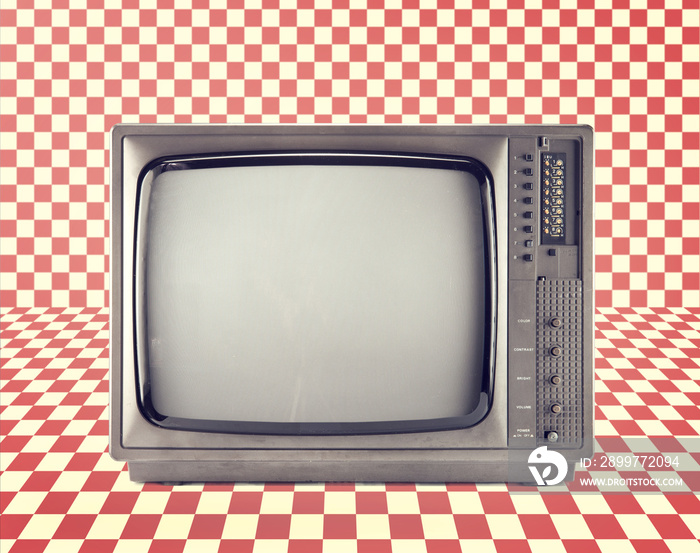 Vintage television isolate on Red checkerboard pattern ,retro technology