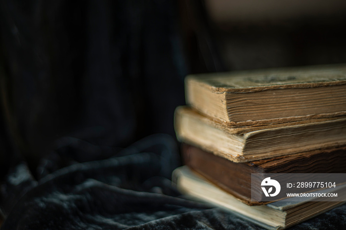 endpaper of vintage books, collection of old antique ancient books on black background, vintage book