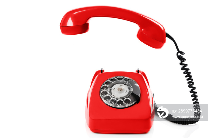 Retro red telephone on white background