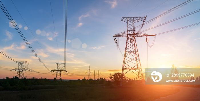 high-voltage power lines at sunset. electricity distribution station .