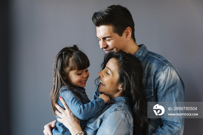 Happy young family with their daughter.