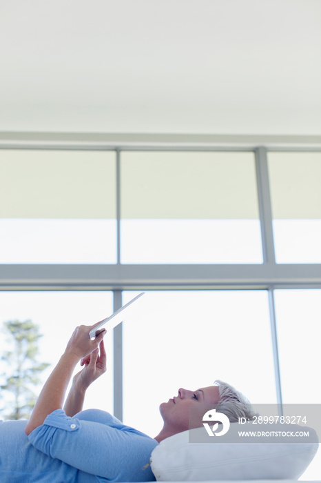 Young woman relaxing with digital tablet