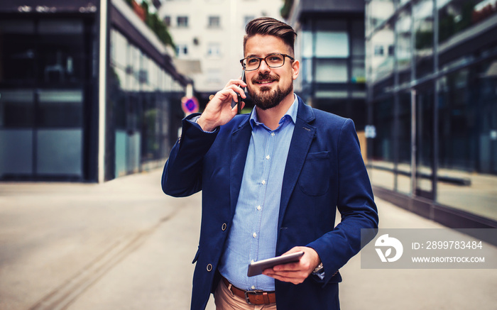 Business man talking on a mobile phone outdoors. Business, education, lifestyle concept