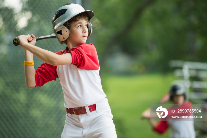 12 year old male batter waiting for pitch