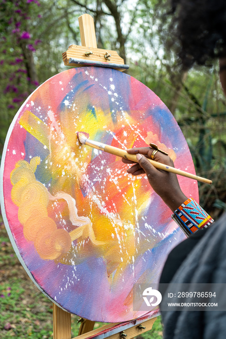 female painter with brush in hand